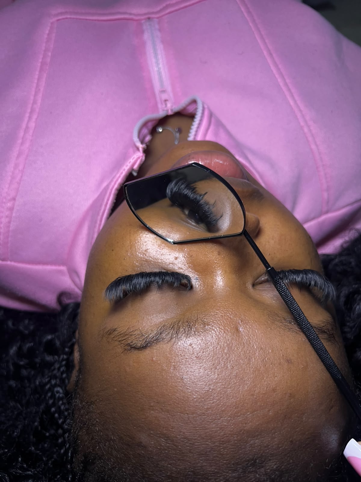 Client receiving lash extension application by Lashes by Viola
